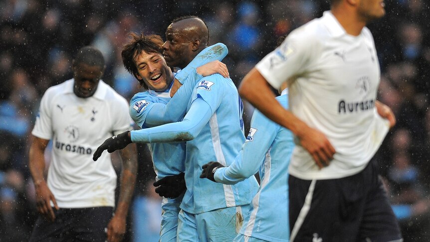 Top of the pile ... Mario Balotelli (2R) struck late from the penalty spot to sink a spirited Spurs outfit.