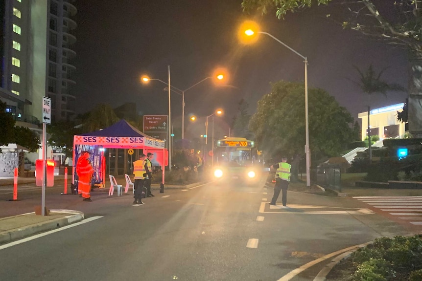 bus being checked by police at nighttime.