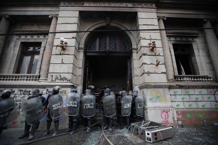 Police surround the Guatemala Congress building after protesters set a part of it on fire