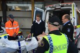Ambulance officers in Tasmania with a defibrillator.