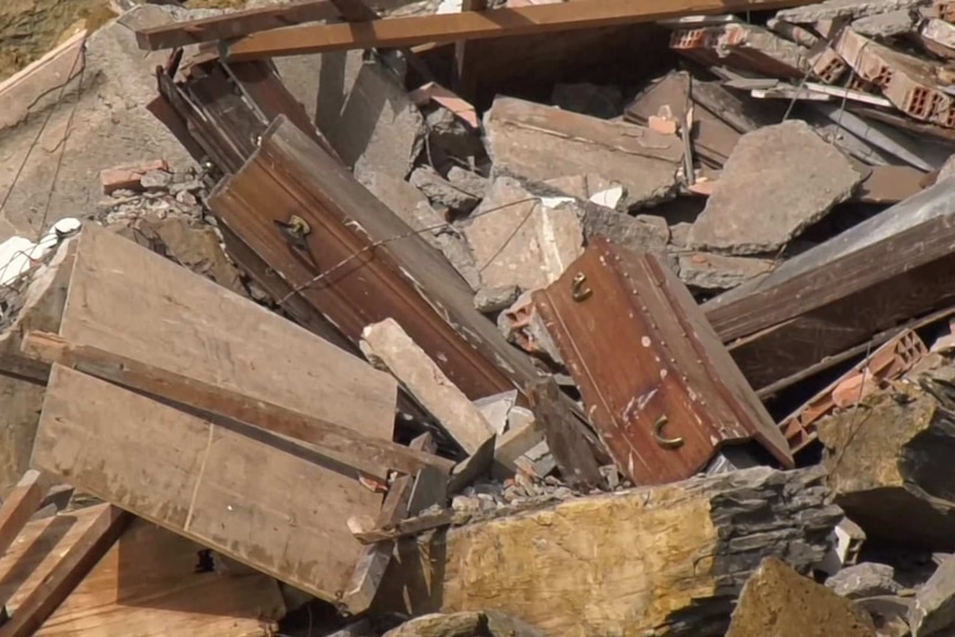 Coffins seen amid rubble