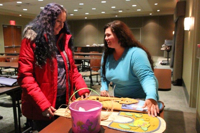 Peta-Joy Williams gets art tips from a student at Spokane Community College in 2014