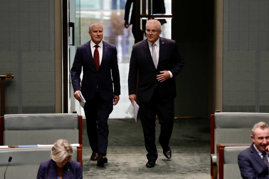 Two men walking into Parliament