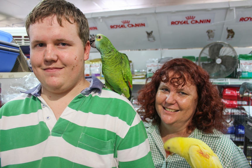 Carter and his mother Rochelle at work with the birds at Sunnybank Hills in Brisbane.
