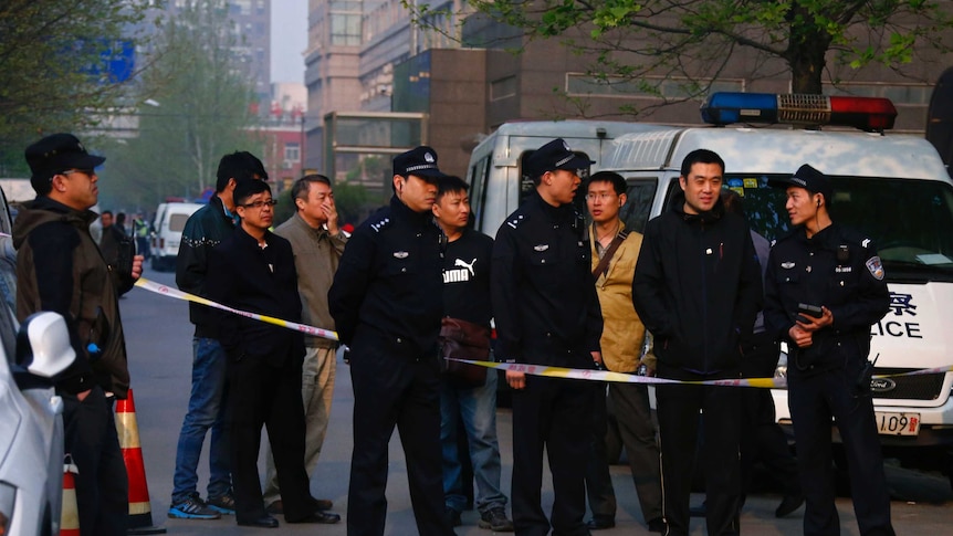 Chinese police stand guard outside court in Beijing