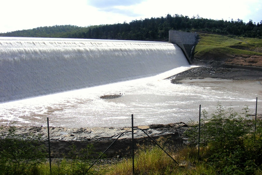 Water flows over the spillway of Paradise Dam near Bundaberg in southern Queensland.