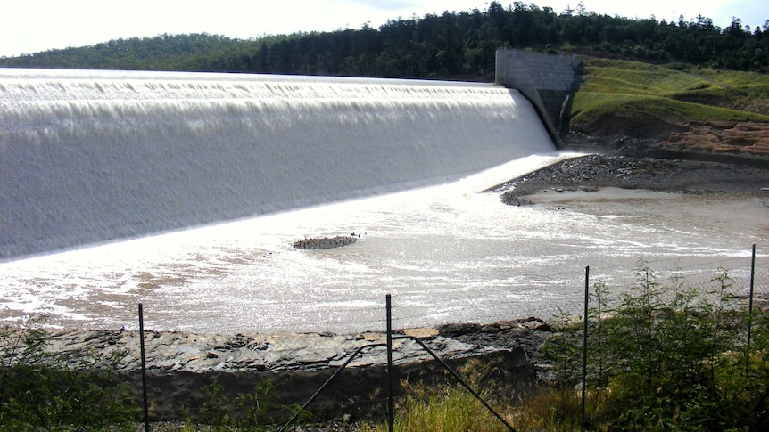 Water flows over the spillway of Paradise Dam near Bundaberg in southern Queensland.