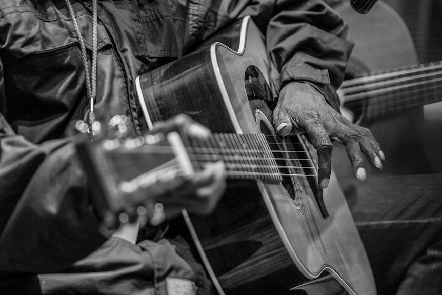 Dr G Yunupingu plays guitar during a rehearsal.