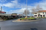 A roundabout surrounded by shops in a country town