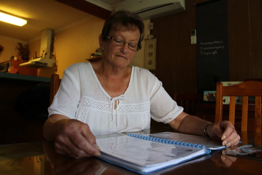 Lorraine Allen looks at documents.