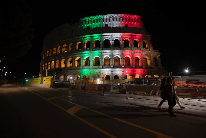 The Colosseum is illuminated in green, white and red.