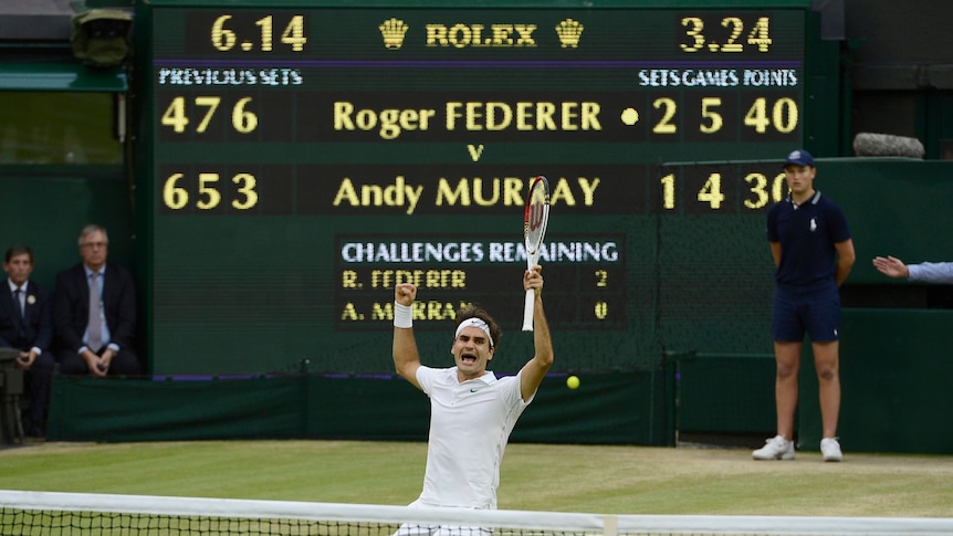 Roger Federer falls to his knees in celebration after beating Andy Murray to win Wimbledon.