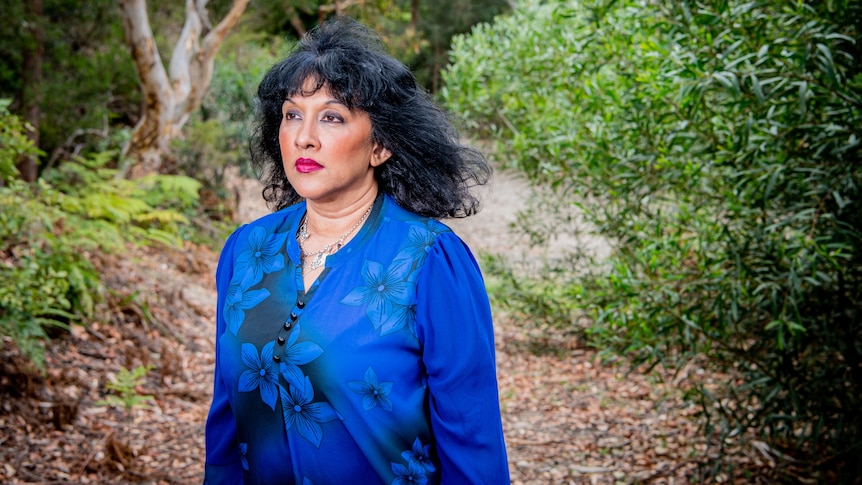 A woman in bushland looking away from the camera