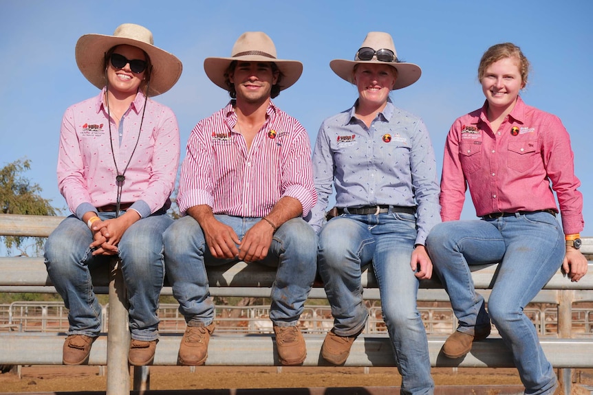 Four young ringers sit on gate