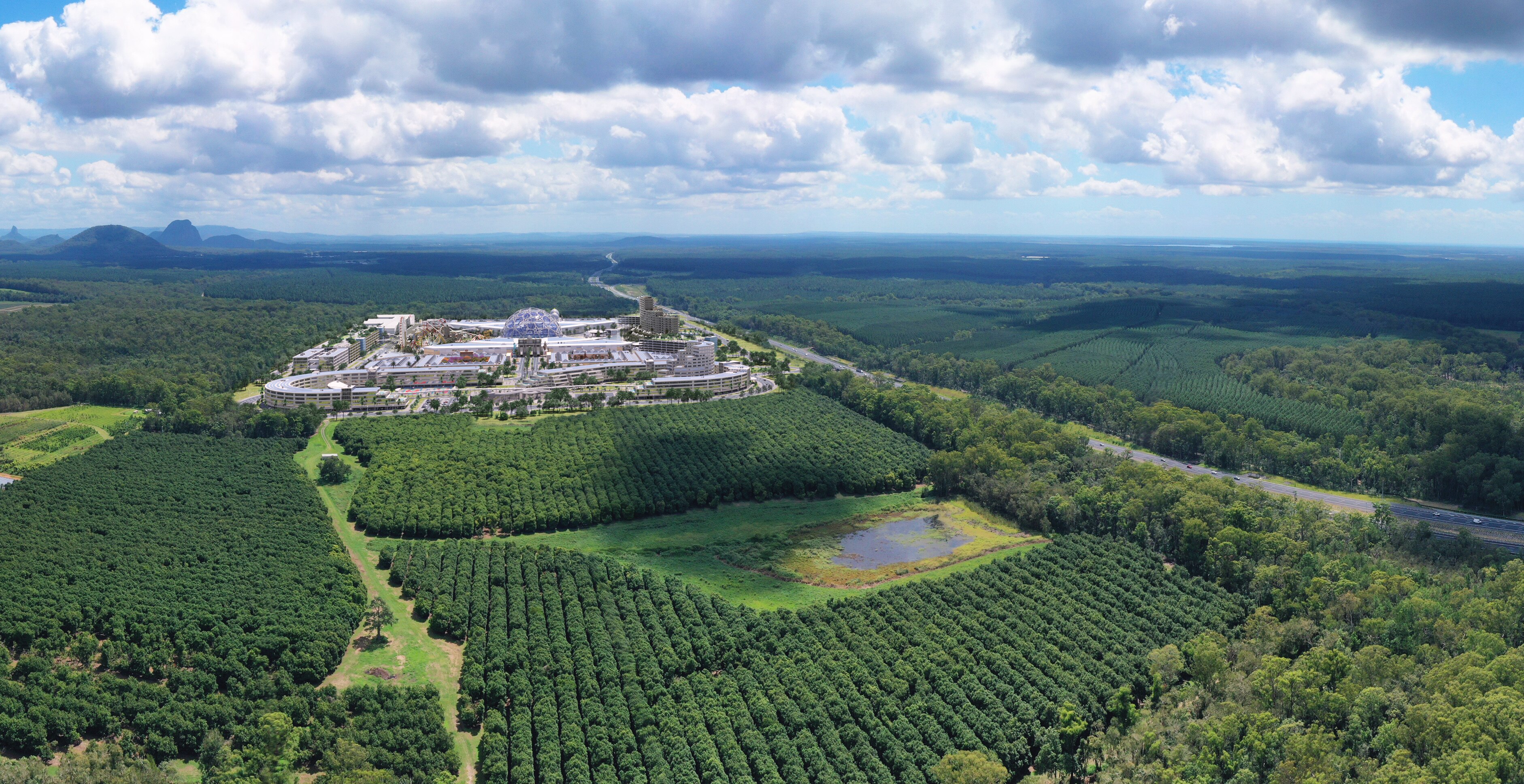 Vista aérea de la representación de un artista de un parque temático dentro de un bosque existente