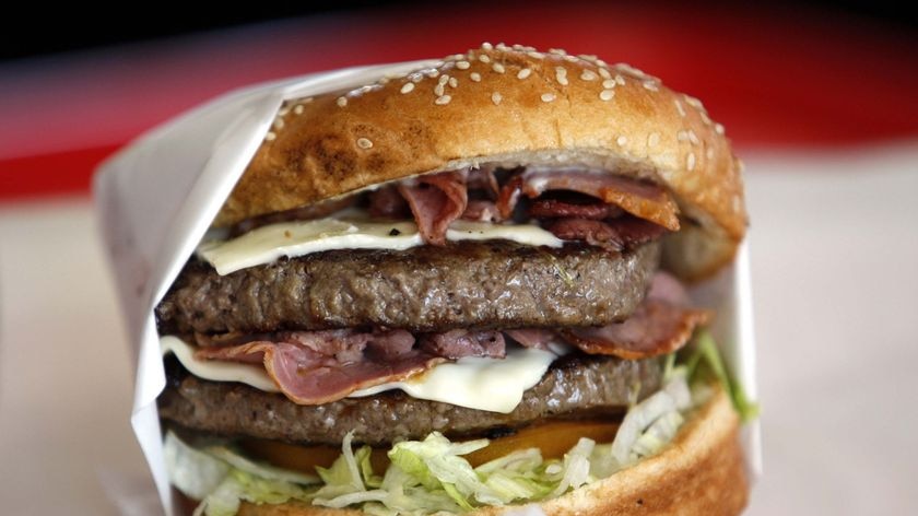 A hamburger sits on a counter