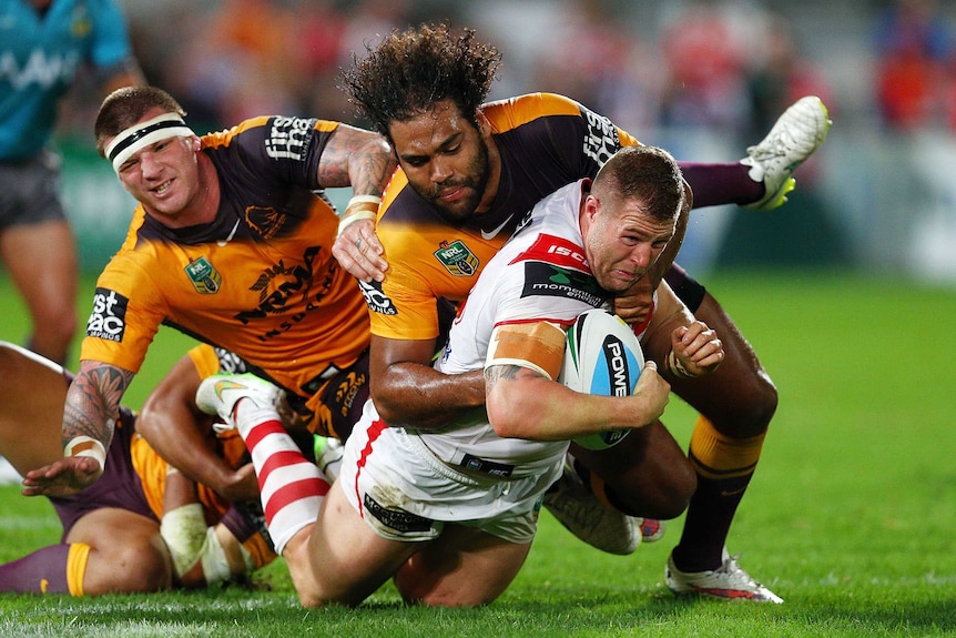 Trent Merrin is tackled by Sam Thaiday