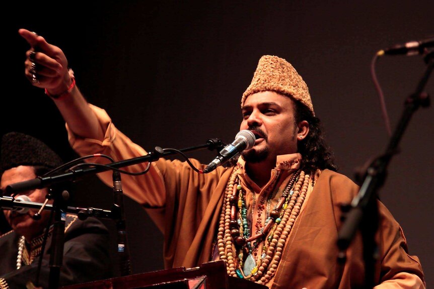 Amjad Sabri performing on stage.
