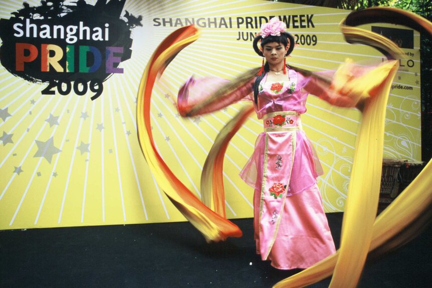 A drag dancer wears traditional Chinese attire during a performance.