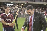 Queensland coach Mal Meninga is sprayed by second rower Carl Webb as they celebrate victory.