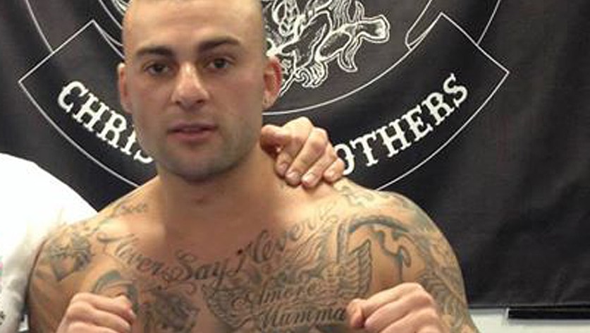 Antonio Bagnato covered in tattoos including one that reads "Saint Michael"