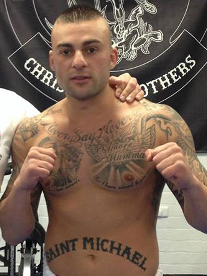 Antonio Bagnato covered in tattoos including one that reads "Saint Michael"
