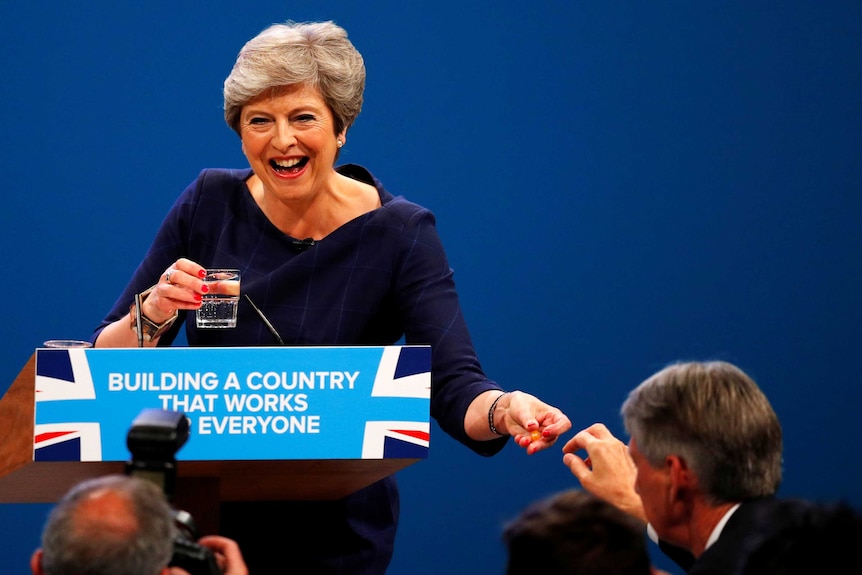 Britain's Chancellor of the Exchequer hands a cough lolly to Prime Minister Theresa May