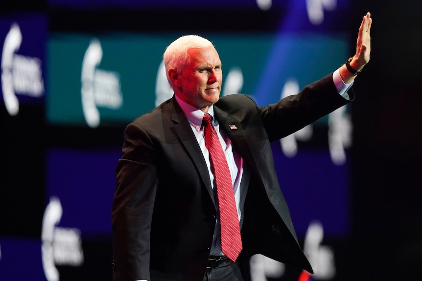 Vice President Mike Pence waves as he walks off the stage