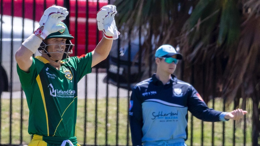 Steve Smith directs fieldsman, as David Warner gestures to the pavilion at Coogee Oval.