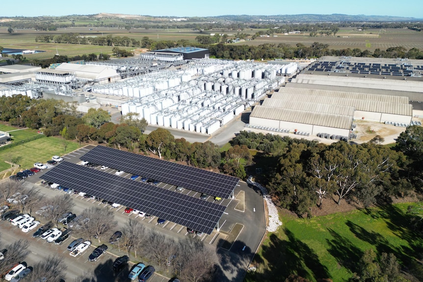 A birds eye view of the production centre with a solar panel car park and solar panels installed on the buildings roof