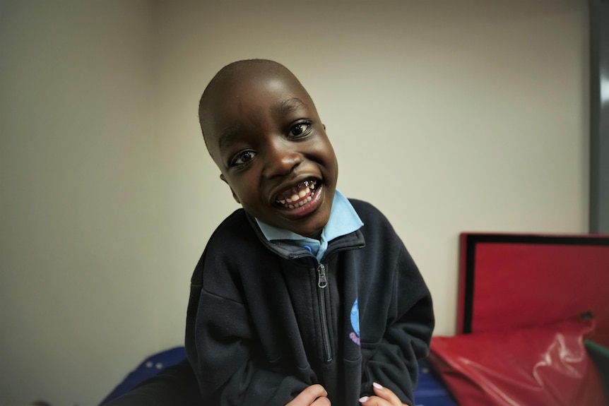 A young boy smiling.