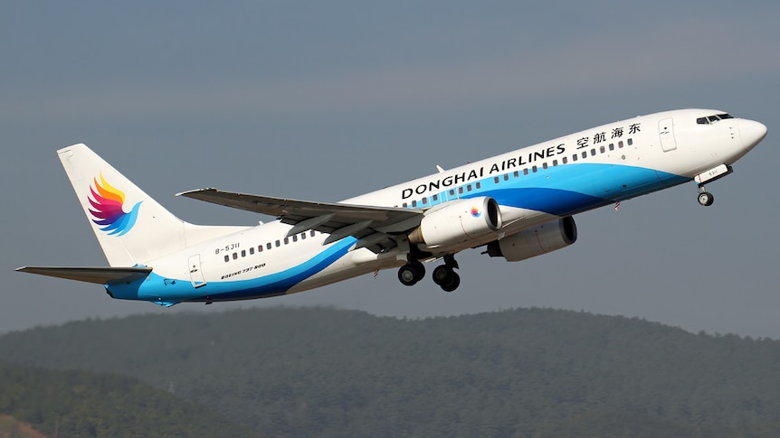 A Dong Hai Airlines-branded plane takes off.