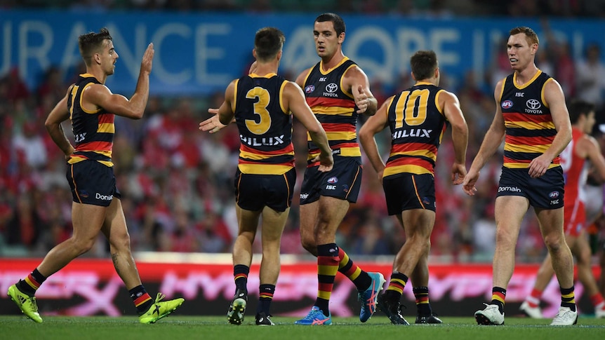 Taylor Walker of the Crows (C) celebrates after scoring a goal against the Sydney Swans.