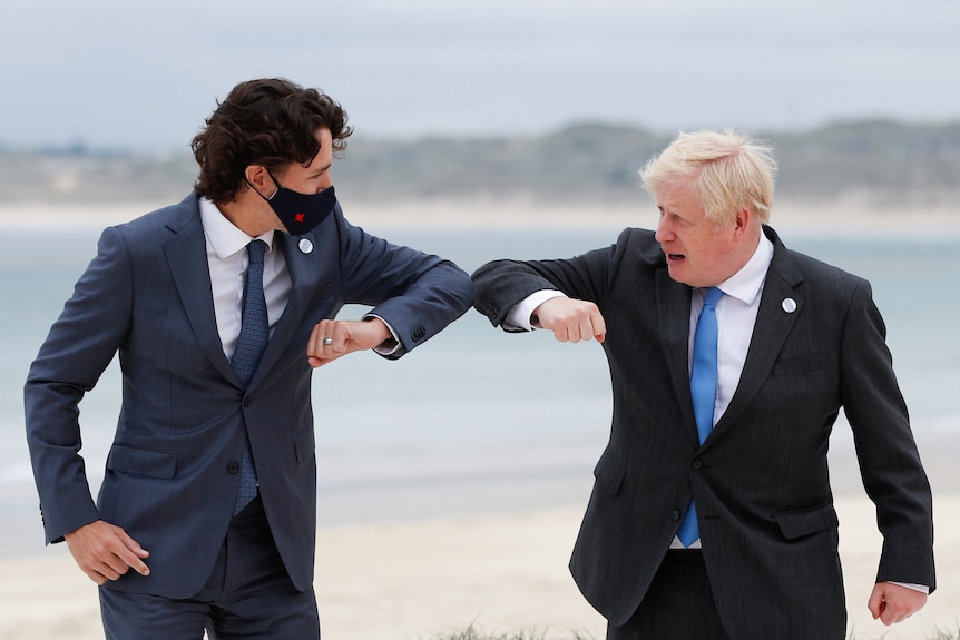 British Prime Minister Boris Johnson, right, greets Canadian Prime Minister Justin Trudeau during arrivals for the G7 meeting.