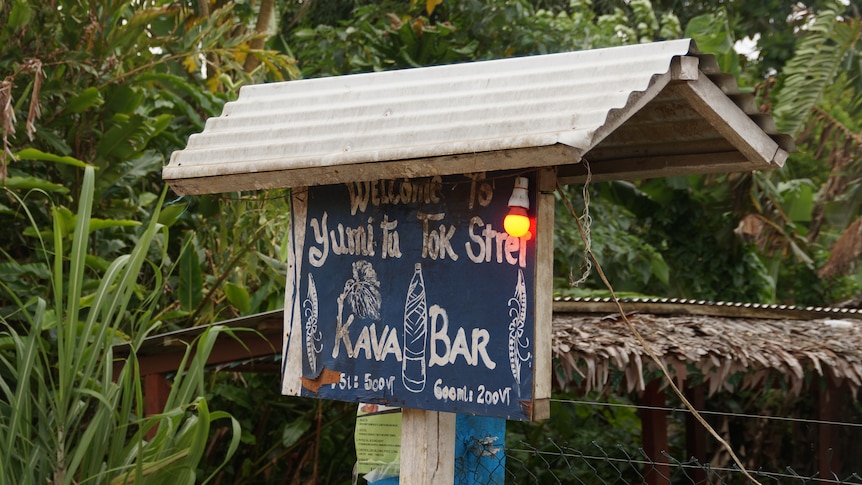 A light is switched on at the front of a kava bar on Santo island in Vanuatu, showing it is open.