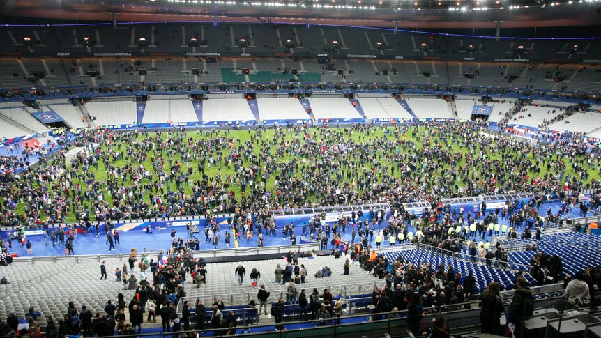 Spectators wait to be allowed to leave Stade de France after France-Germany soccer international.