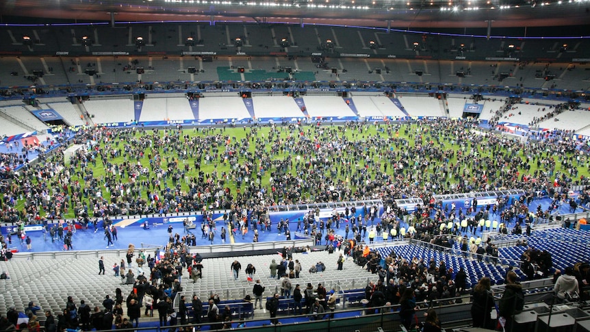 Spectators wait to be allowed to leave Stade de France after France-Germany soccer international.