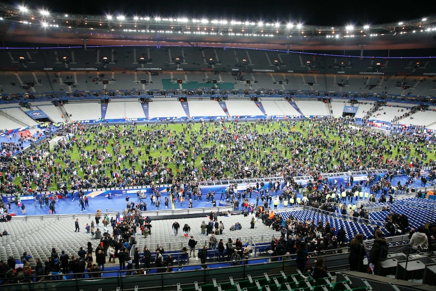 Spectators flock to the pitch on Stade de France