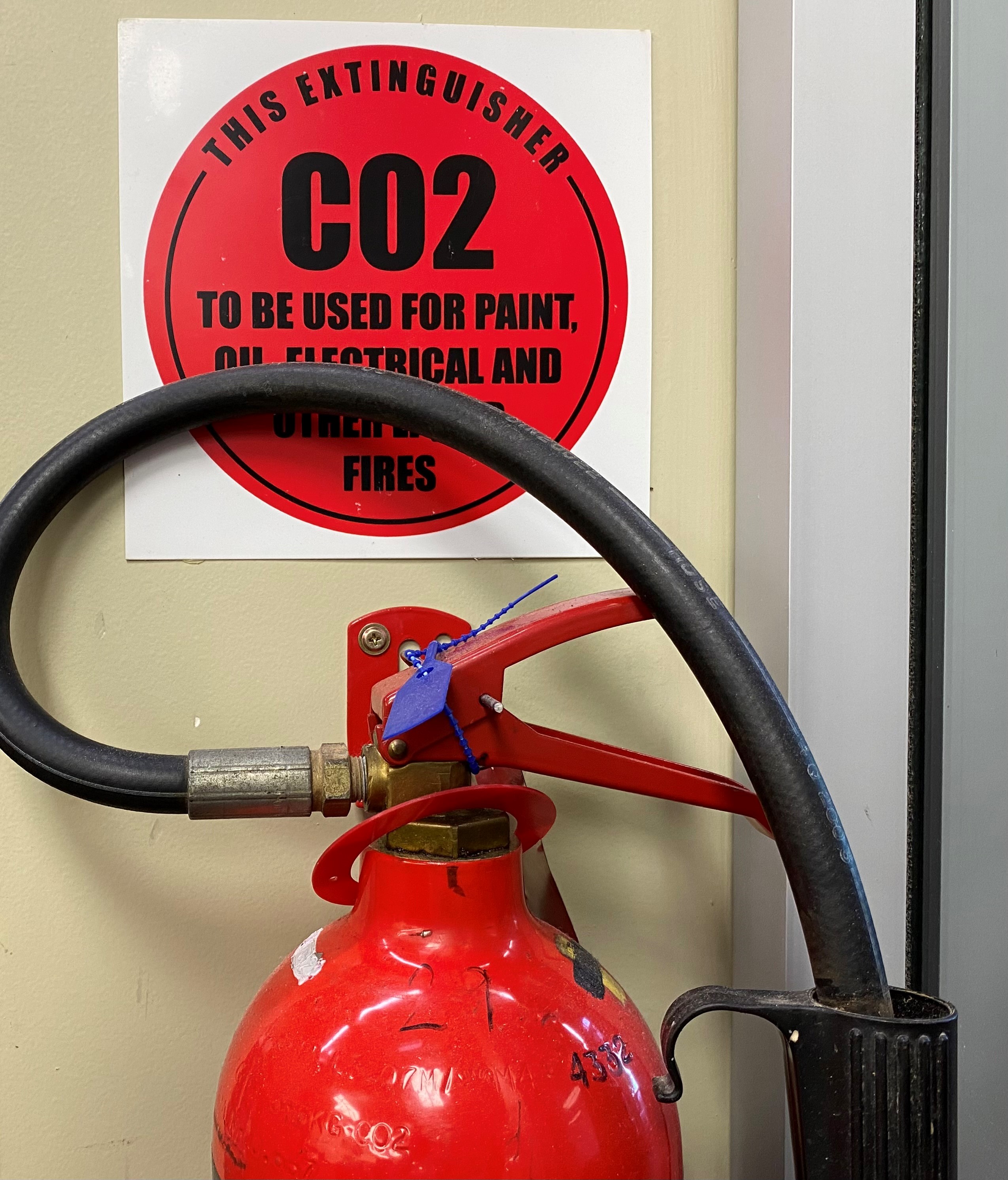 A close up of a red fire extinguisher
