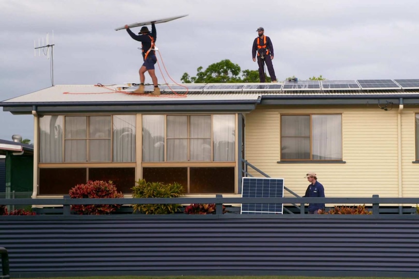 Workers installing solar panels