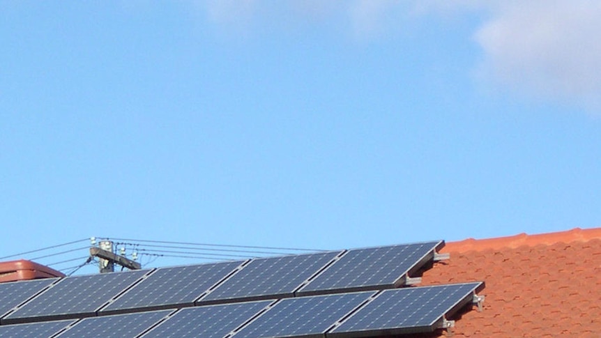 Solar panels on roof of house and hot water system