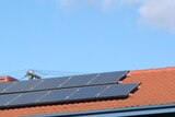 Solar panels on roof of house and hot water system