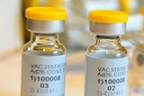 Vials of vaccines sit on top of a medical form