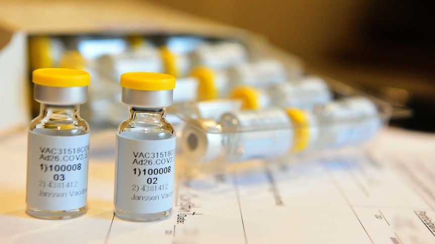 Vials of vaccines sit on top of a medical form