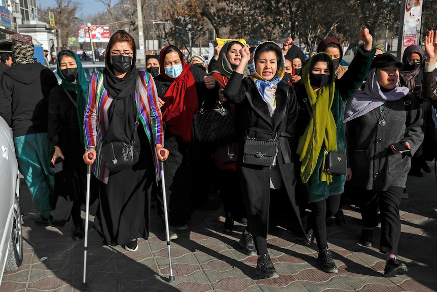 Afghan women chant slogans during a protest against the ban on university education for women.