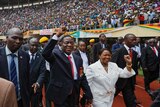 Emmerson Mnangagwa (c) and his wife Auxillia, centre-right, arrive at the presidential inauguration ceremony
