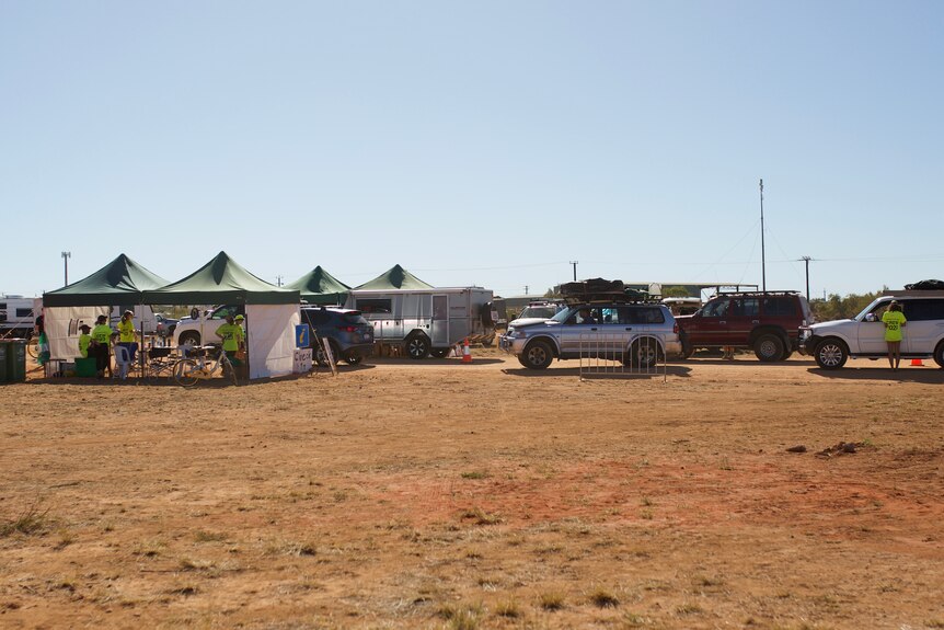 A line of four wheel drives queue up to enter the campsite.