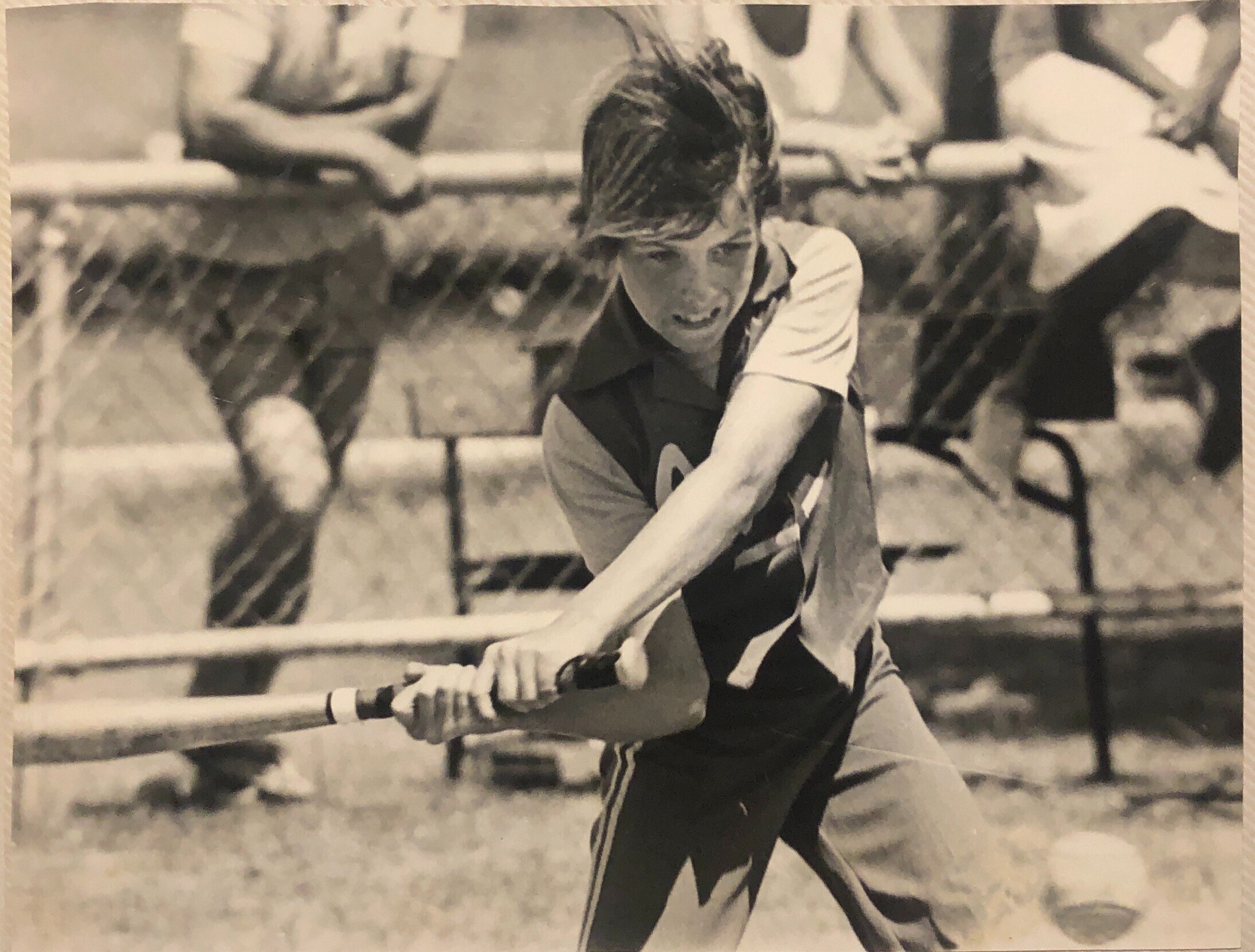 Girl holding a softball bat. 