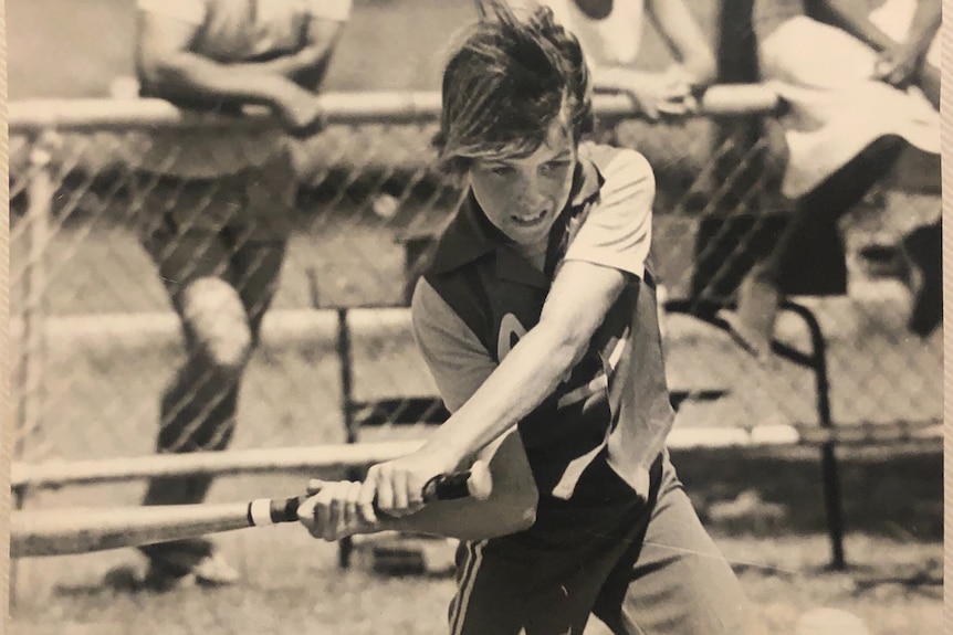 Girl holding a softball bat. 