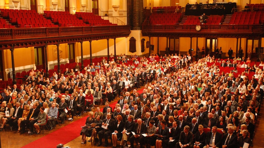 Guests attend the memorial service for celebrated news journalist Peter Harvey at Sydney Town Hall